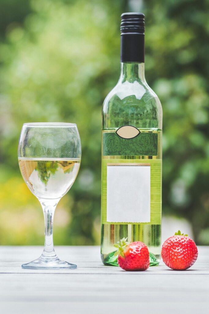 White wine glass bottle with strawberries